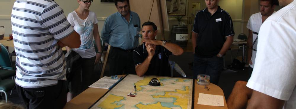National Maritime College image boat licence students learning how to read a nautical chart
