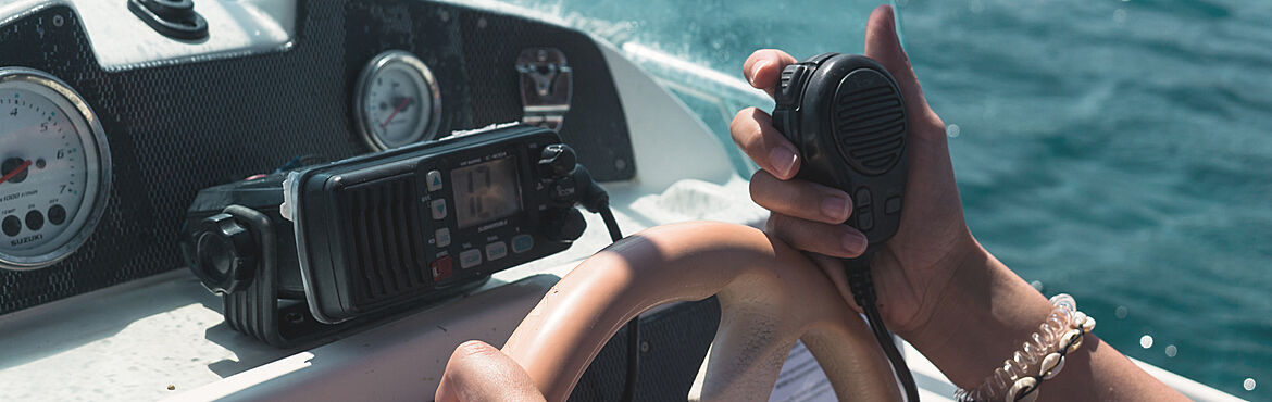 Person using marine radio on boat